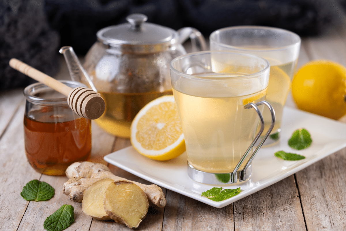 Thé au gingembre avec miel et citron dans une tasse sur une table en bois